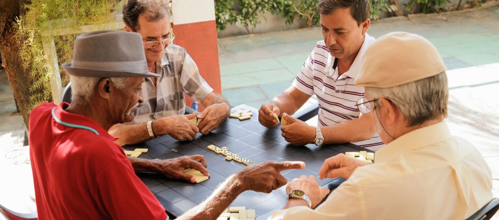 a group of people playing dominos